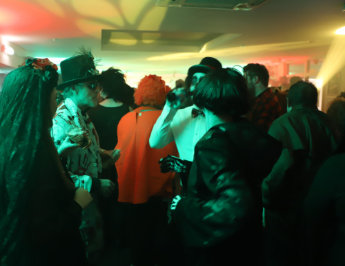 Guests mingle at the Halloween party